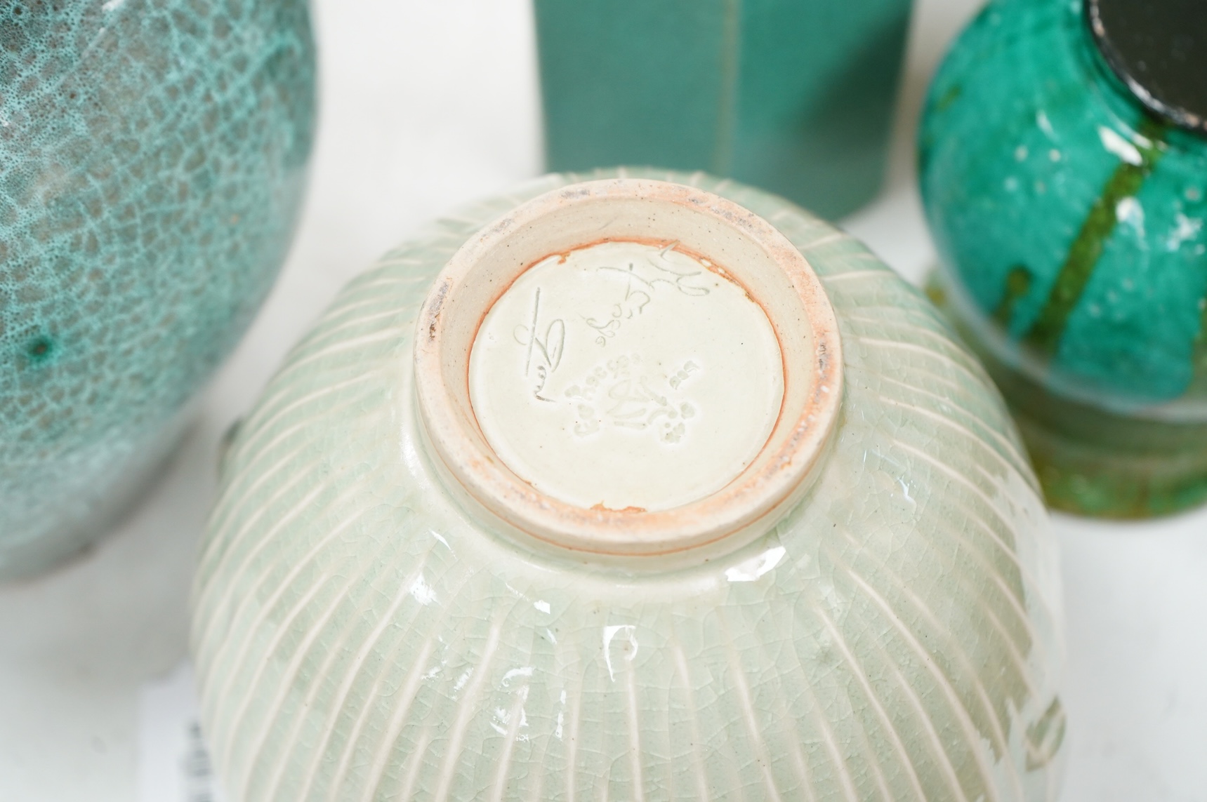 A group of Continental green glazed earthenware vessels including a crystal glazed jug, largest 29cm high